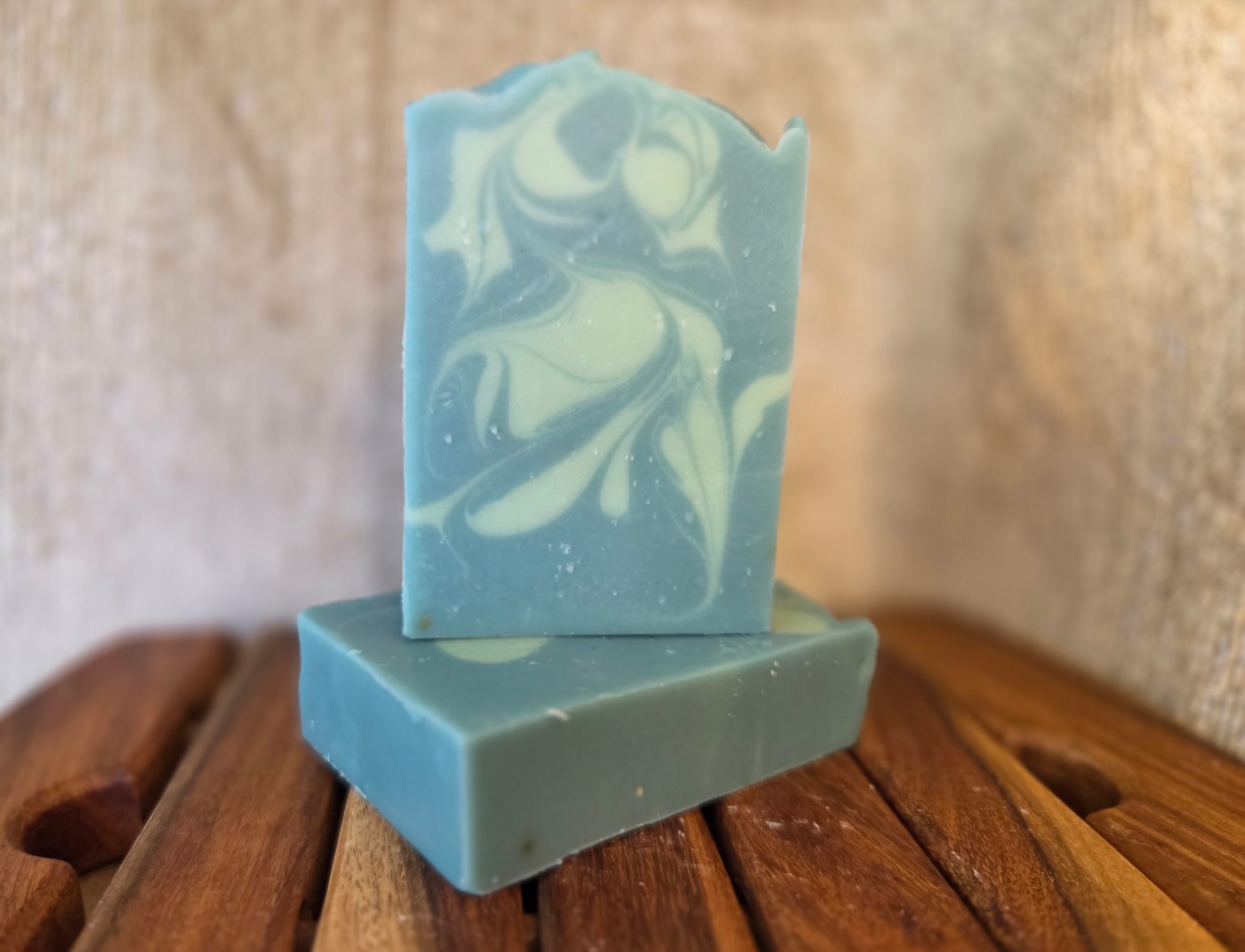 Teal-blue soap bars with cream swirls